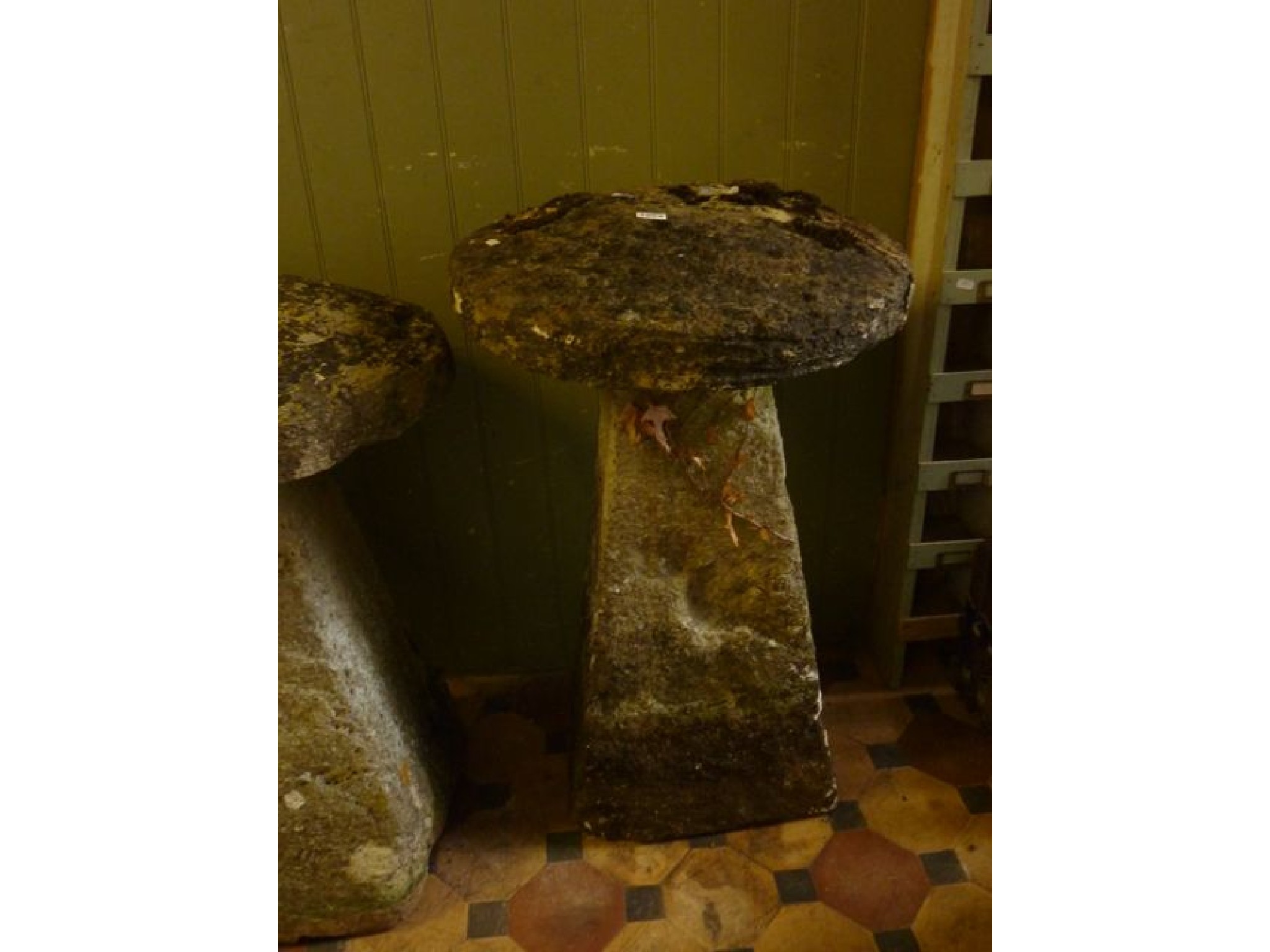 Appraisal: A weathered tall natural stone staddle stone and domed cap