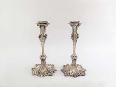 Appraisal: A pair of Victorian candlesticks on writhen foliage bases tapering