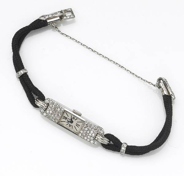 Appraisal: A lady's diamond and platinum watch with black cord strap