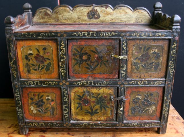 Appraisal: A small Tibetan storage cupboard of six panels each painted