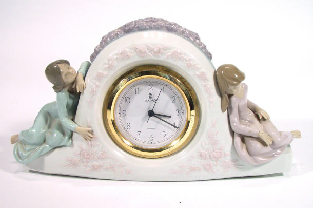 Appraisal: Lladro porcelain mantle clock modelled with two sleeping figurines factory