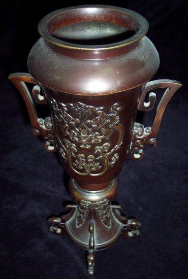 Appraisal: A Japanese bronze twin-handled vase with relief moulded decoration set