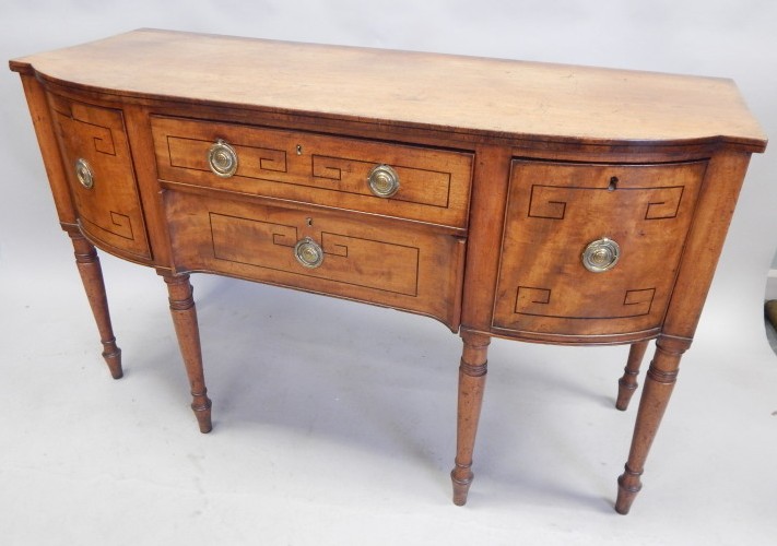 Appraisal: An early thC mahogany and ebony strung bow fronted sideboard