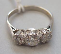 Appraisal: A diamond set three stone ring claw set with cushion