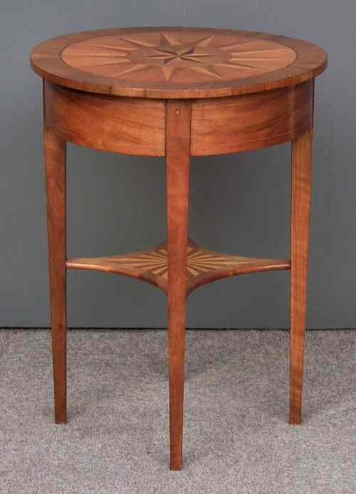 Appraisal: A French walnut and marquetry circular occasional table with star