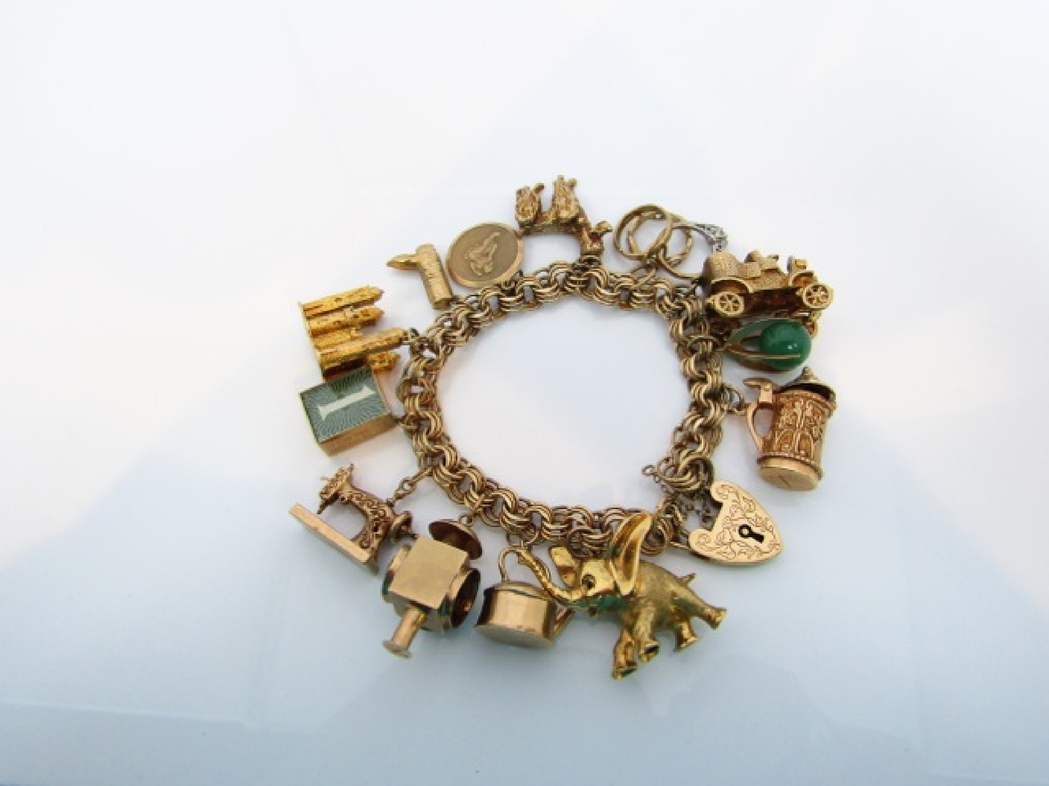 Appraisal: A ct gold charm bracelet suspended with thirteen various ct