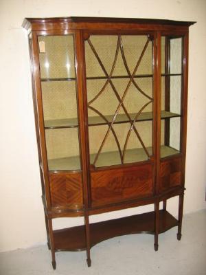 Appraisal: AN EDWARDIAN MAHOGANY DISPLAY CABINET of oblong serpentine form with