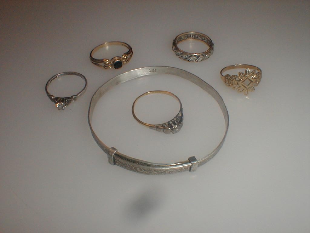 Appraisal: Five various rings and a tension sprung silver bangle