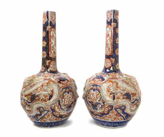 Appraisal: A Large Pair of Japanese Imari Bottle Vases having molded