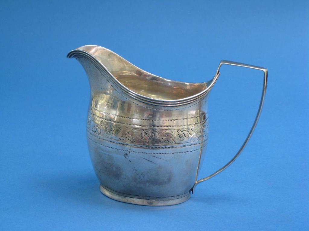 Appraisal: A George III oval Cream Jug with bright cut engraved