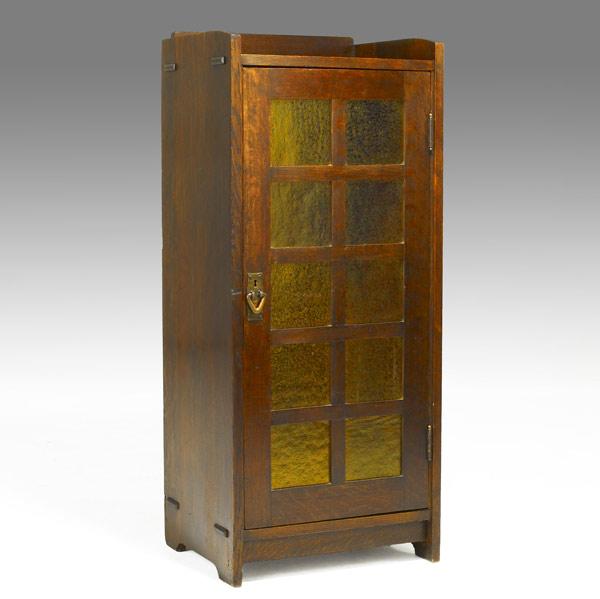 Appraisal: GUSTAV STICKLEYAmber glass music cabinet with four adjustable shelvesRed decal