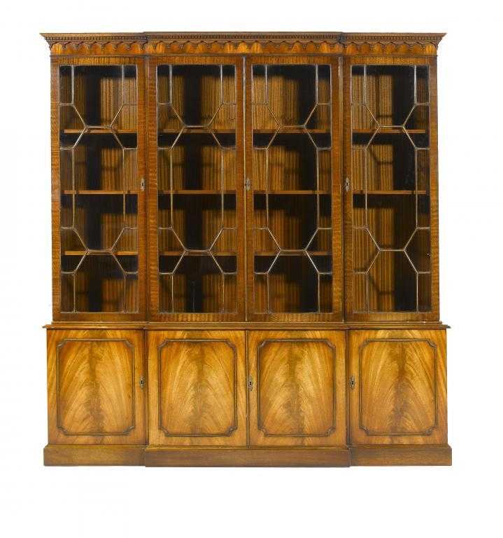 Appraisal: A MAHOGANY BREAKFRONT BOOKCASE in George III style with dentil