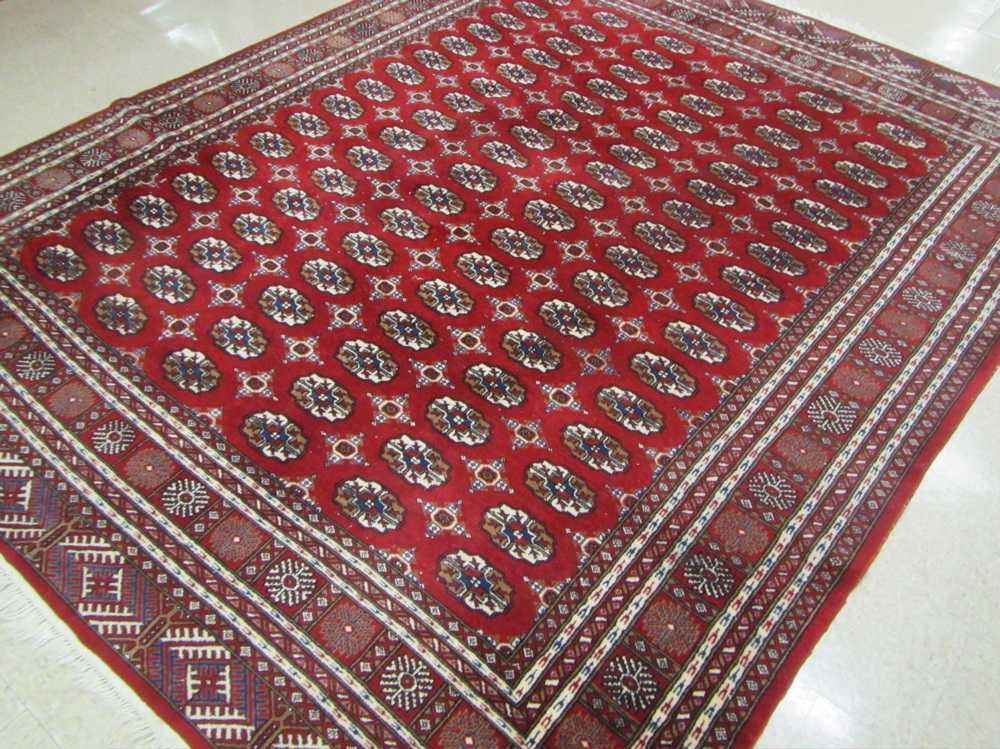 Appraisal: HAND KNOTTED ORIENTAL CARPET Pakistani Bokhara repeating columns of Turkoman