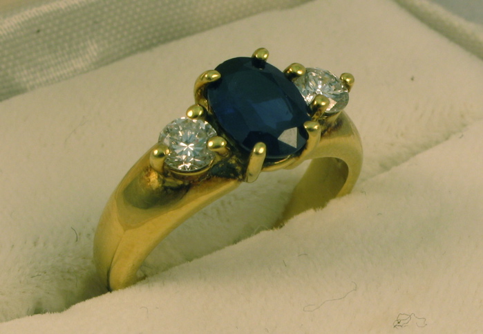 Appraisal: SAPPHIRE DIAMOND AND EIGHTEEN KARAT GOLD RING set with an