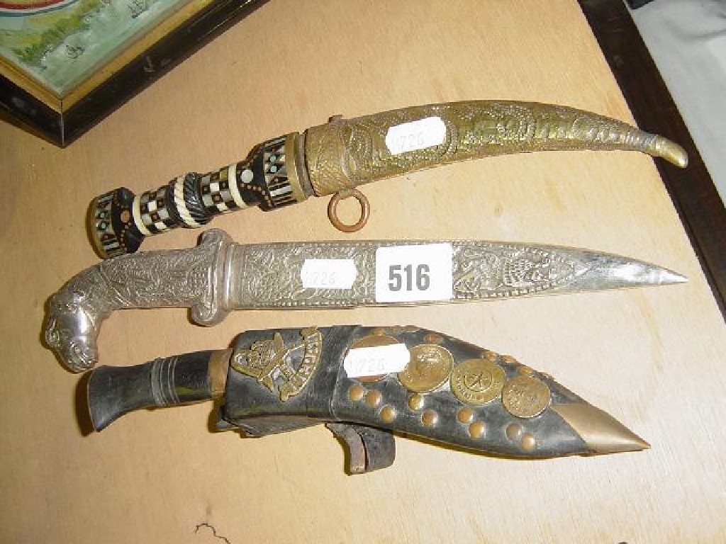 Appraisal: An Eastern dagger with brass sheath and handle inlaid with