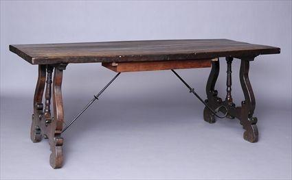 Appraisal: ITALIAN BAROQUE-STYLE WALNUT TRESTLE TABLE The rectangular overhang top above