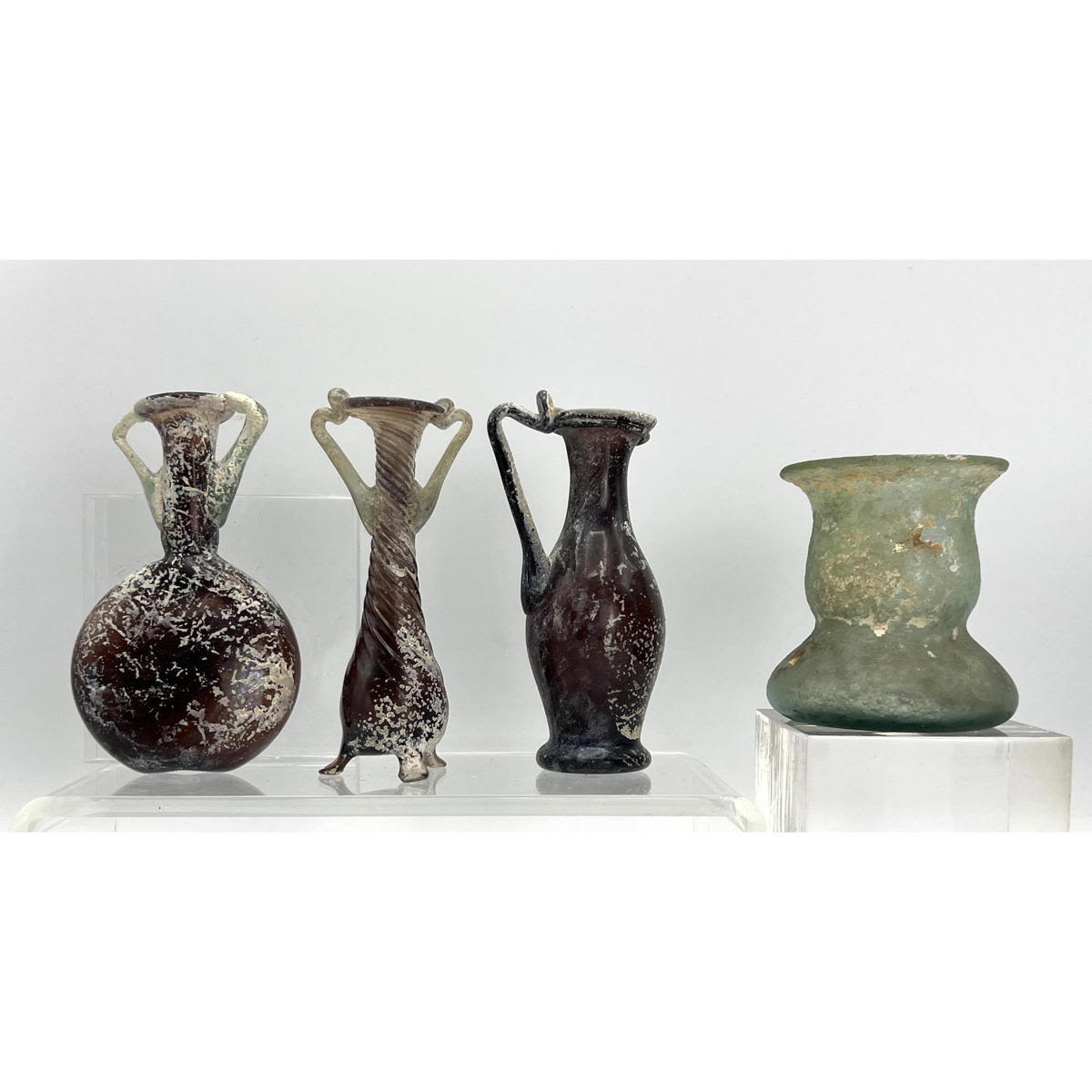 Appraisal: pc lot Ancient Roman glass vases and a vessel Dimensions