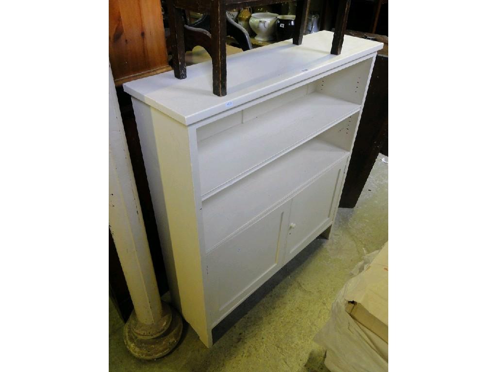 Appraisal: An Edwardian oak bookcase cupboard with single adjustable shelf over