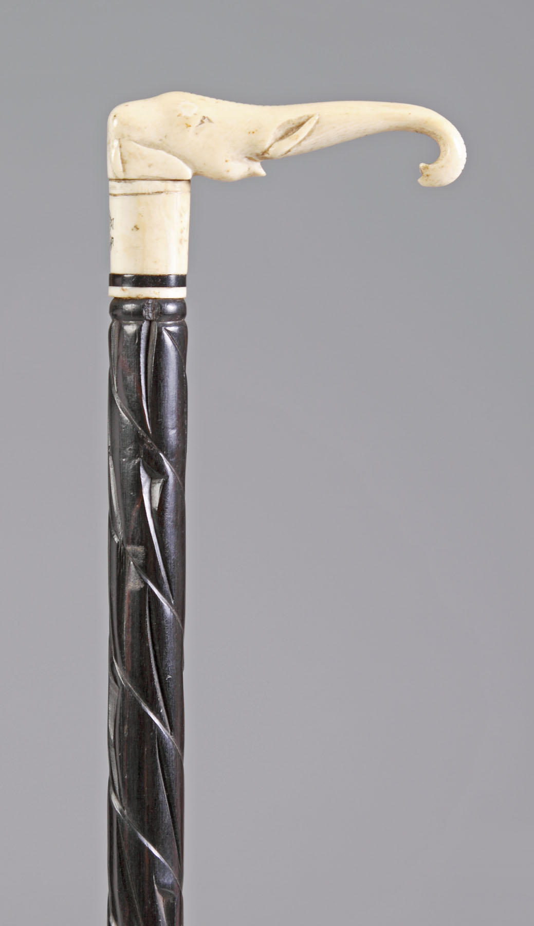 Appraisal: Carved Ivory Elephant Head Cane Carved ebony shaft Monogrammed Ht