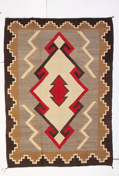 Appraisal: A Navajo rug Centering a hooked diamond lozenge flanked by