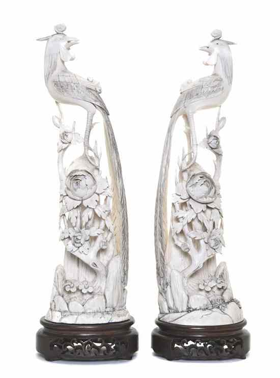 Appraisal: A Pair of Chinese Ivory Birds each depicted standing atop