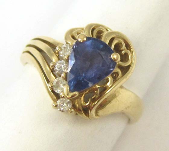 Appraisal: TANZANITE DIAMOND AND FOURTEEN KARAT GOLD RING set with four