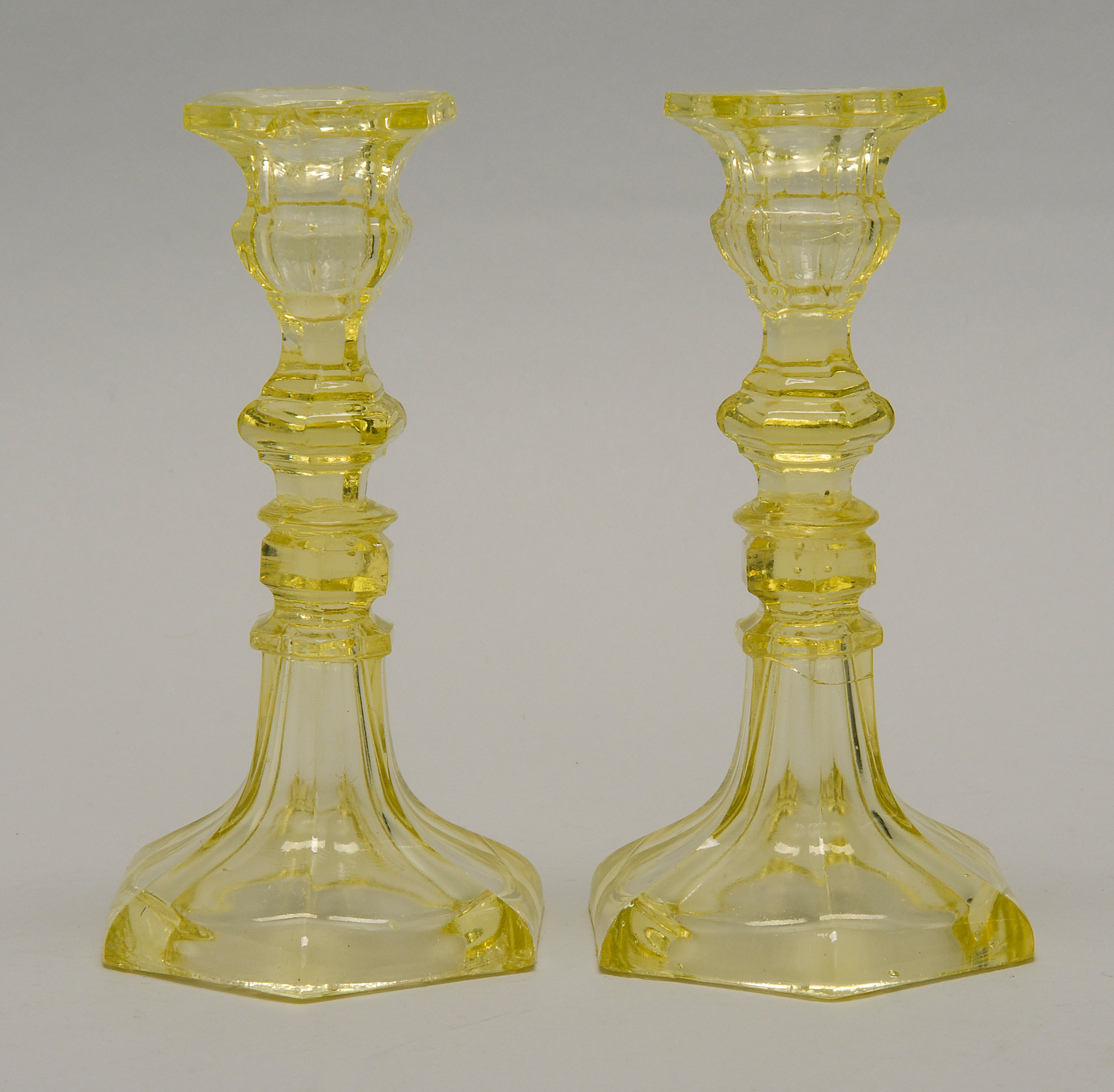 Appraisal: PAIR OF TH CENTURY CANARY YELLOW SANDWICH GLASS CANDLESTICKS in