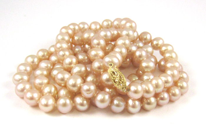 Appraisal: OPERA LENGTH PEARL NECKLACE having pink pearls and a karat