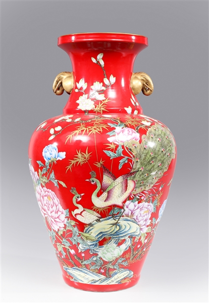 Appraisal: Elaborate Chinese red ground porcelain vase with peacocks parched atop