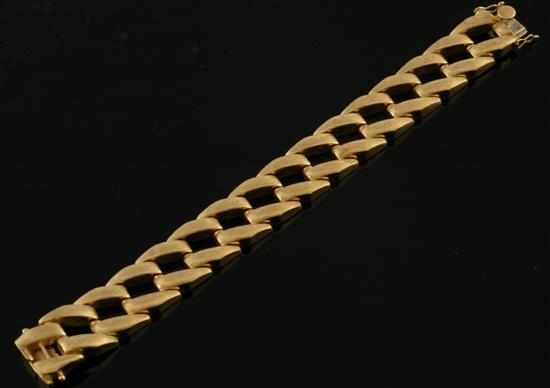 Appraisal: A gold cocktail bracelet Comprising articulated links in textured finish