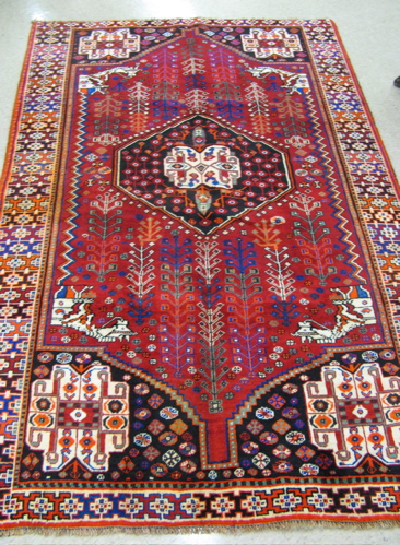 Appraisal: PERSIAN SHIRAZ AREA RUG central geometric medallion and surrounding stylized