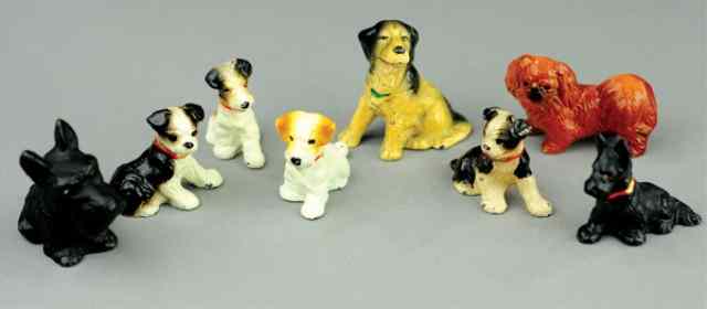 Appraisal: CAST IRON DOG PAPERWEIGHTS Grouping of assorted breeds very colorful