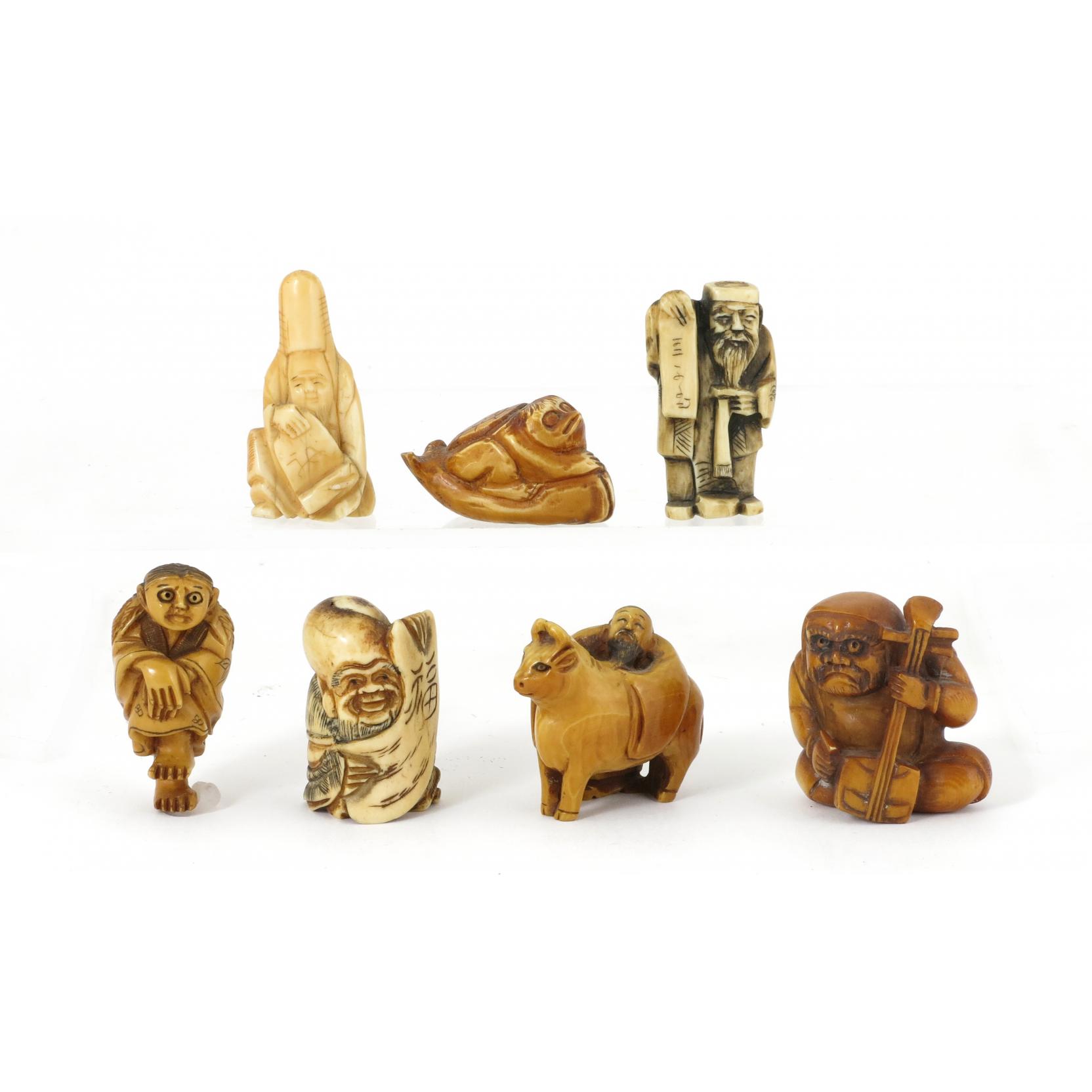 Appraisal: Group of Japanese Netsuke Figures includes four tea stained ivory