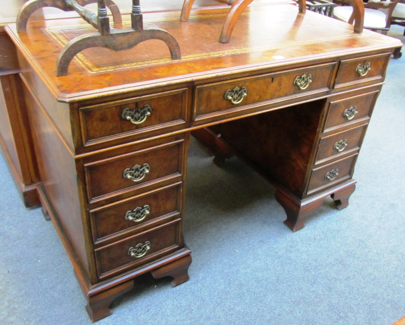 Appraisal: An th century style figured walnut pedestal desk with nine