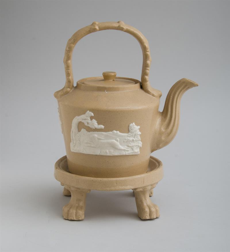 Appraisal: ENGLISH FAWN-GROUND POTTERY TEAPOT AND A STAND With two relief