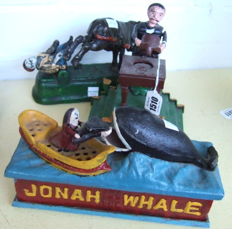 Appraisal: Three cast iron money boxes th century Jonah and the