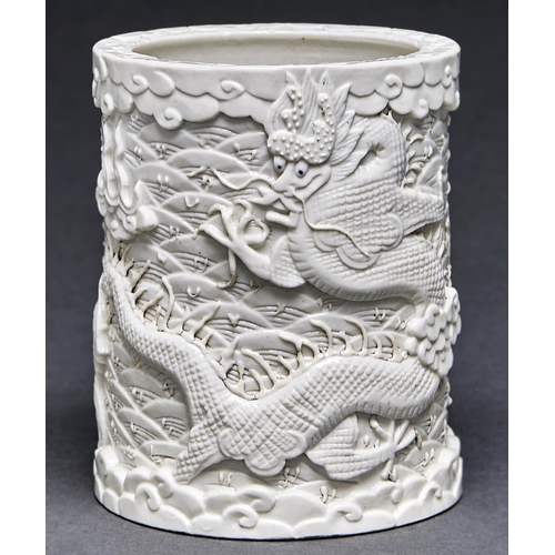 Appraisal: A Chinese blanc de chine brush pot carved with dragons