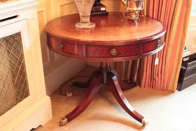 Appraisal: A GEORGIAN STYLE CIRCULAR DRUM LIBRARY TABLE with leather inset