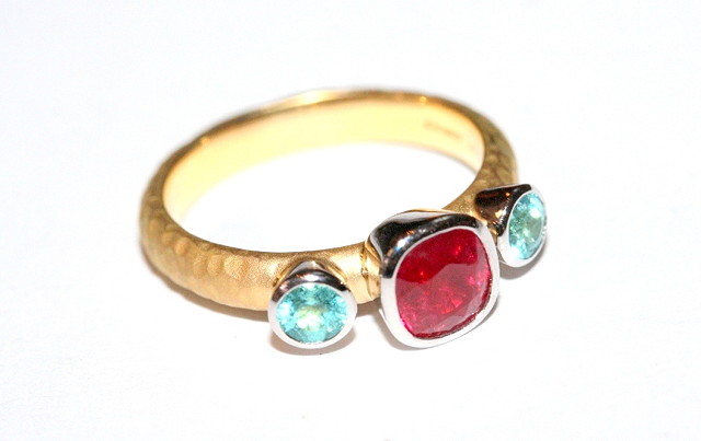 Appraisal: A CONTEMPORARY RUBY AND TOURMALINE RING cushion cut ruby mounted