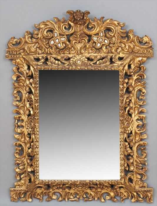 Appraisal: SPANISH COLONIAL-STYLE CARVED GILTWOOD WALL MIRROR The arched mirror-inset crest