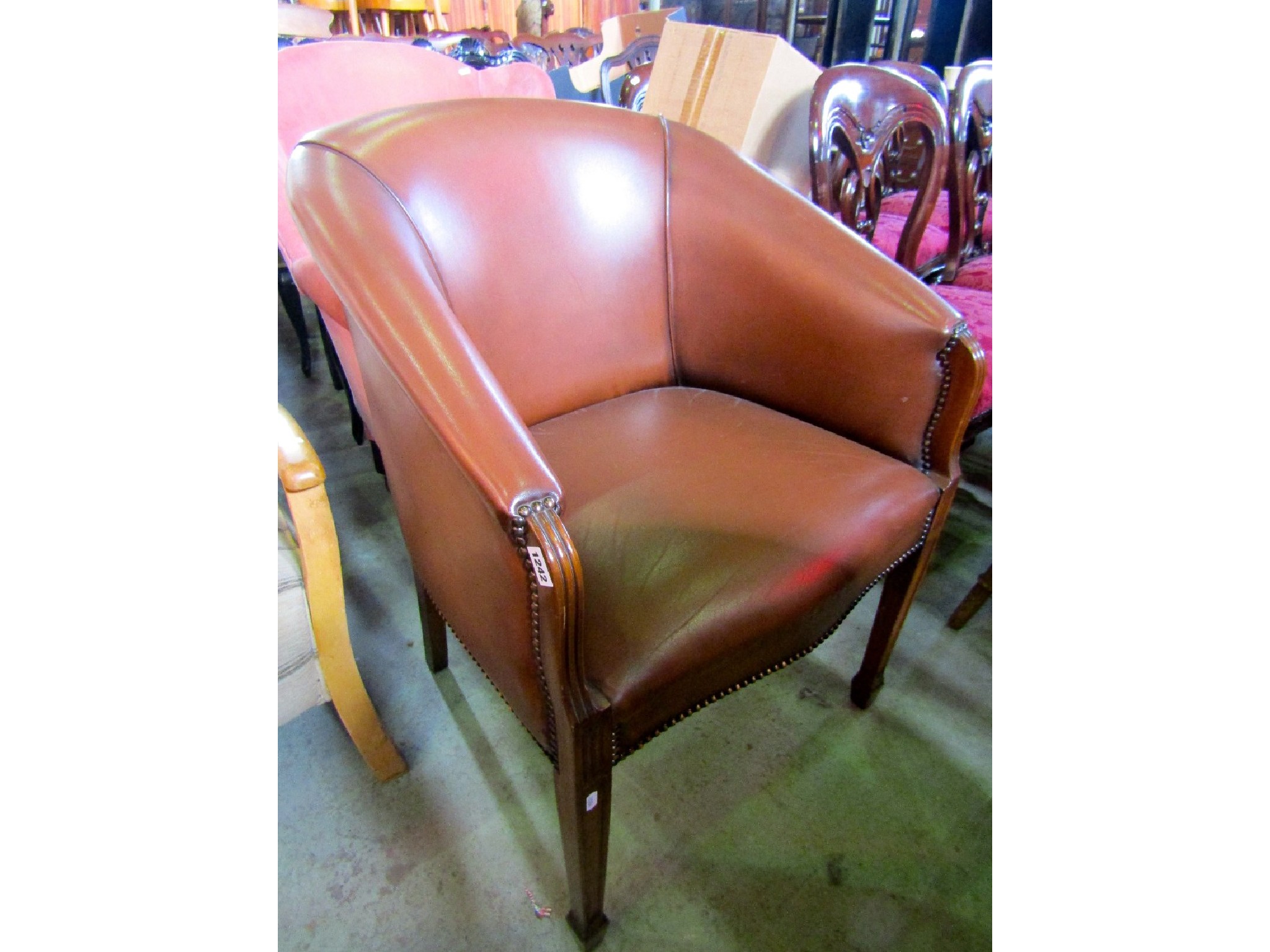 Appraisal: A contemporary brown leather upholstered tub chair the seat with