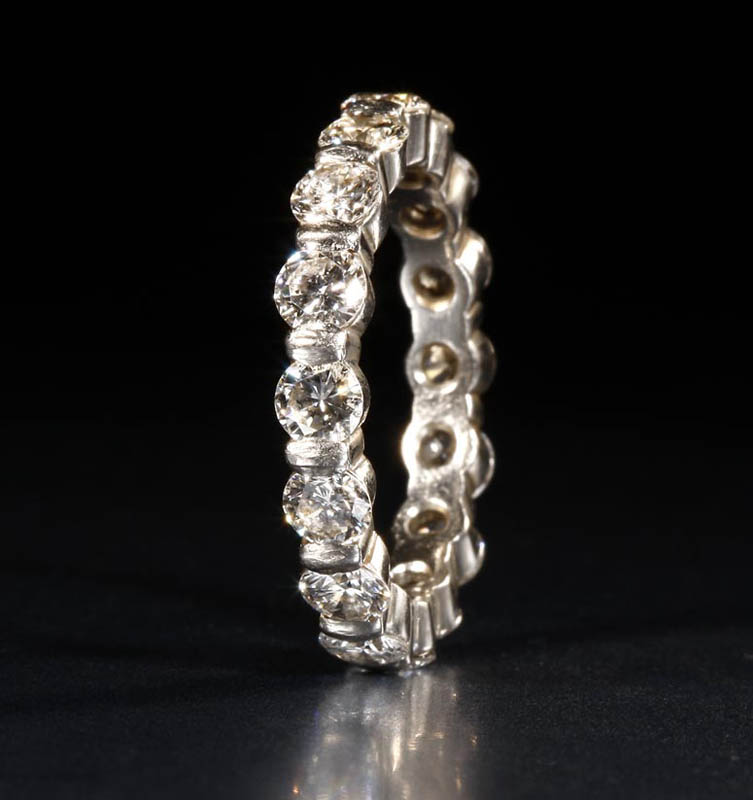 Appraisal: A platinum and diamond eternity band A platinum and diamond