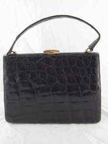 Appraisal: A lady's dark crocodile skin handbag with suede leather lining