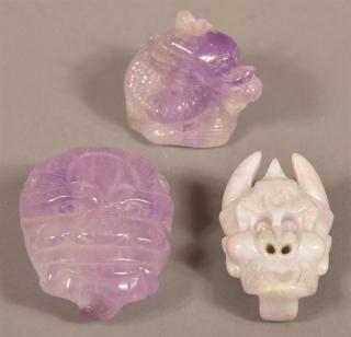 Appraisal: Three Pieces of Carved Amethyst Stone Two Devil mask sash