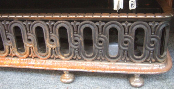 Appraisal: A Victorian steel fire fender with pierced frieze decoration and