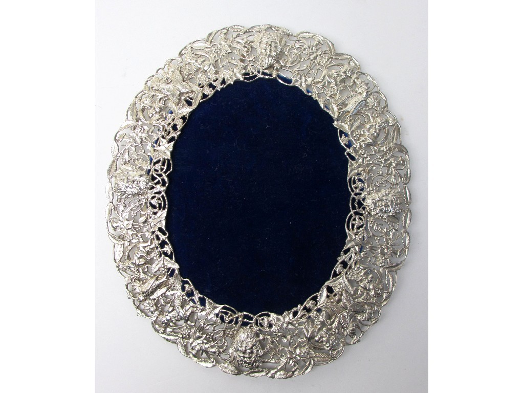 Appraisal: A fretwork white metal photograph frame of oval shape profusely