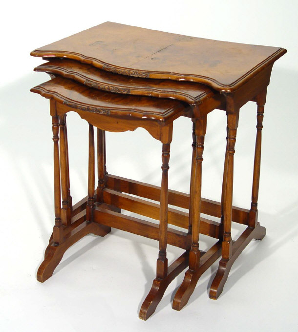 Appraisal: Nest of three walnut occasional tables with serpentine fronts on