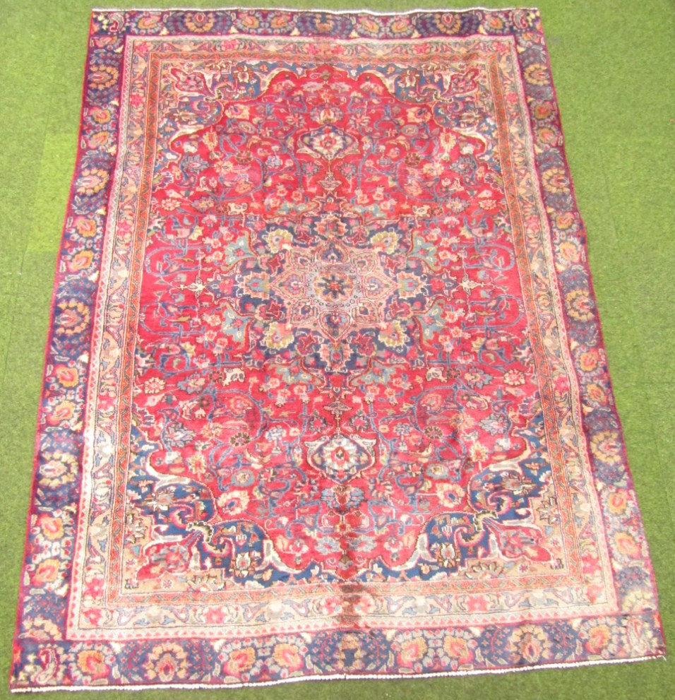 Appraisal: A Mashad rug medallion style in red and ink blue