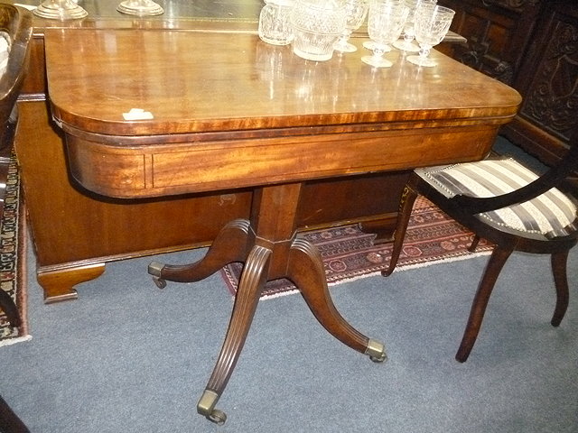 Appraisal: A VICTORIAN MAHOGANY FOLD OVER CARD TABLE standing on faceted