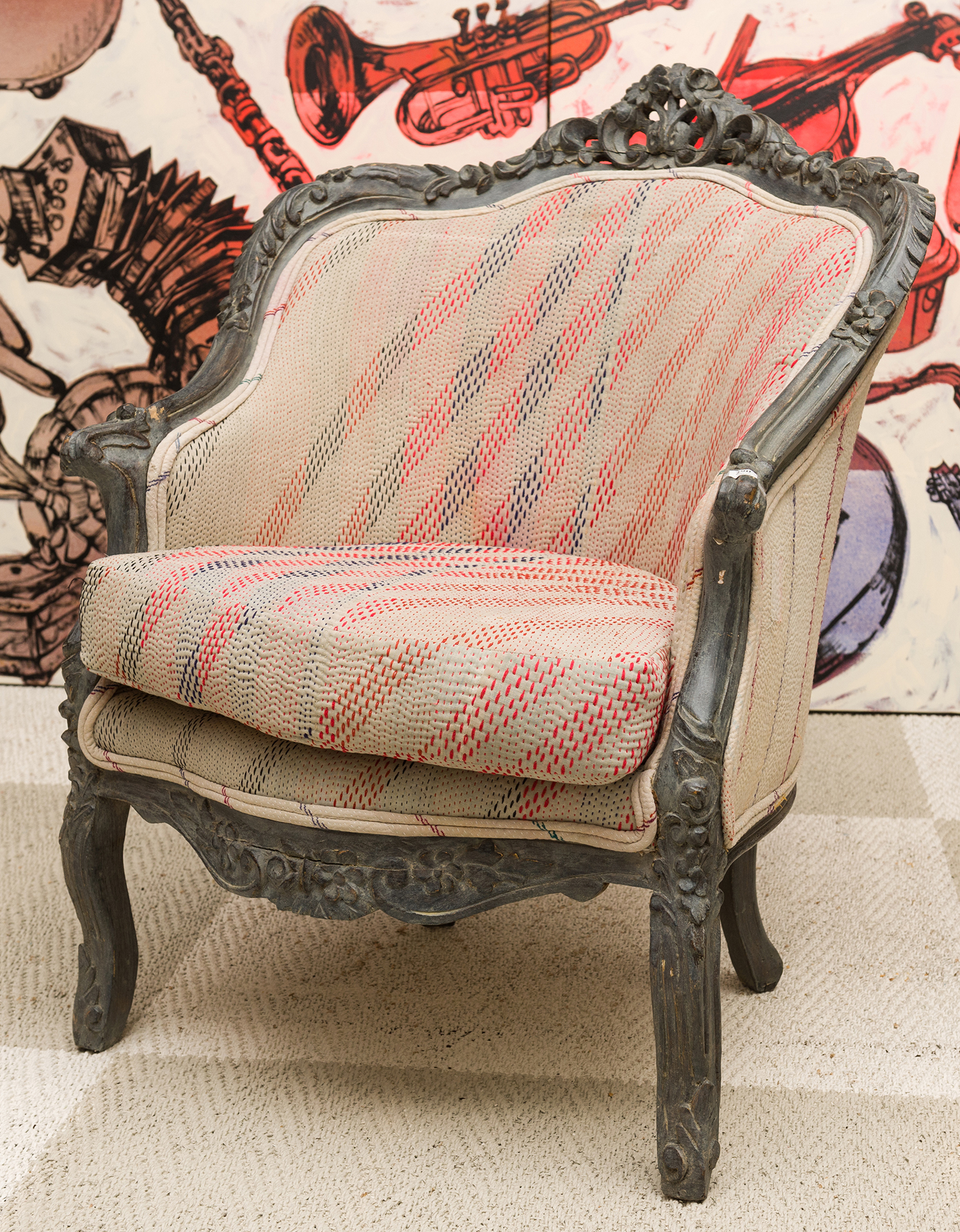 Appraisal: AN ORNATELY CARVED CONTINENTAL STYLE ARMCHAIR IN MODERN UPHOLSTERY h